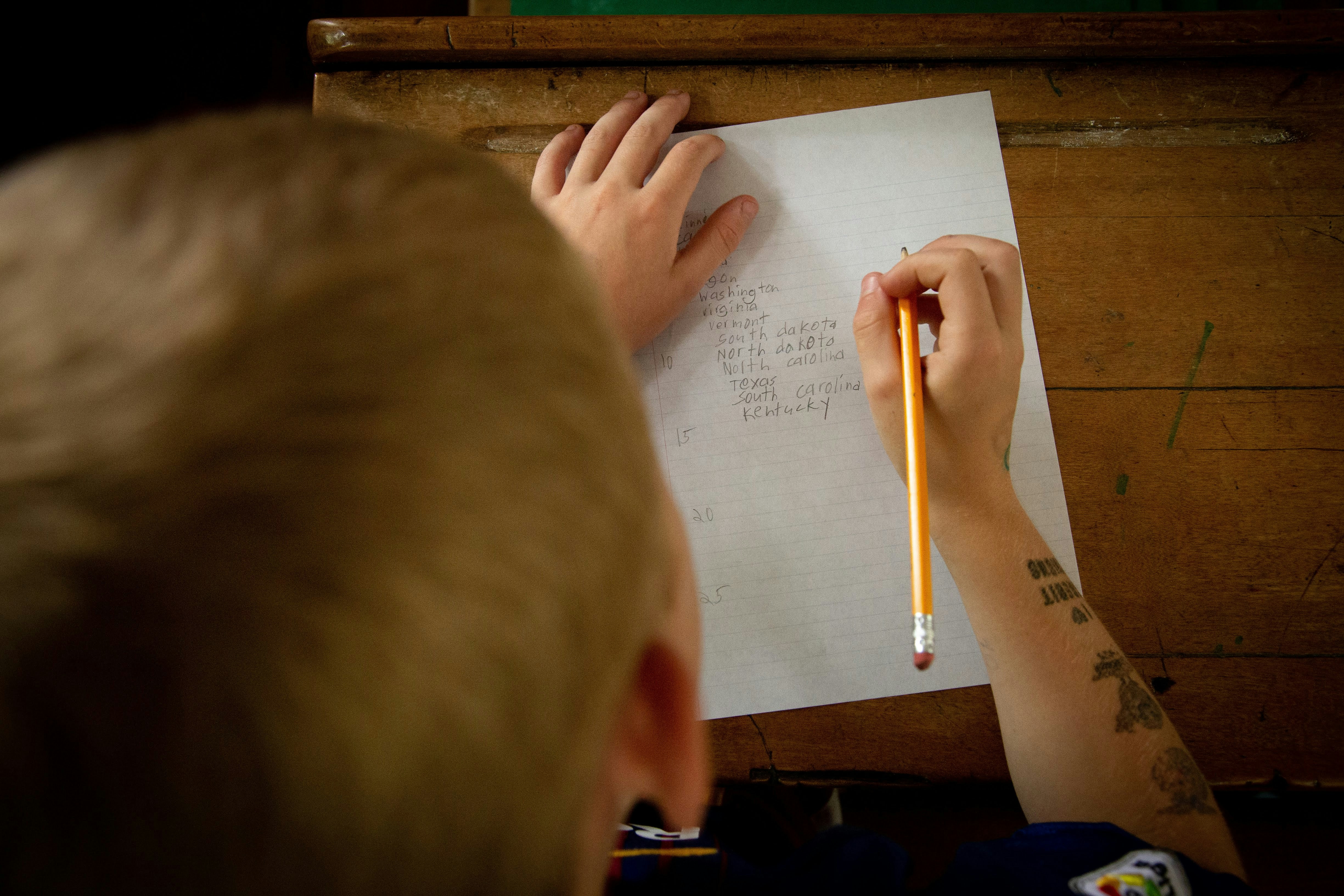 person writing on paper